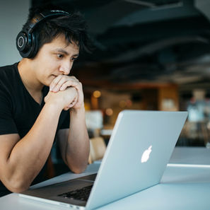 student staring at computer nervously waiting for the IB result