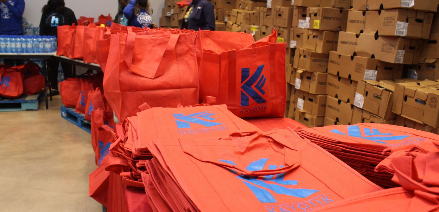 Kayotik Foundation tote bags packed for a community food distribution