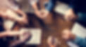 Group of people holding hands praying wo
