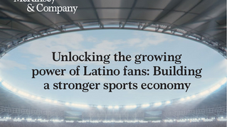 Cover page of a McKinsey & Company report titled “Unlocking the Growing Power of Latino Fans: Building a Stronger Sports Economy.” The image shows a brightly lit modern stadium filled with spectators under a curved roof, symbolizing large-scale sports engagement and audience energy.