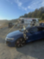 Blue Audi with EVO motion controlled robot mounted on the car with other filming equipment. Mountains and sky background. Audi 2025, Motorized Precision.