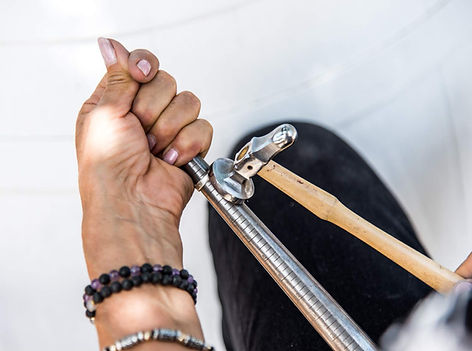 A hammered ring on a mandrel being struck my a hammer