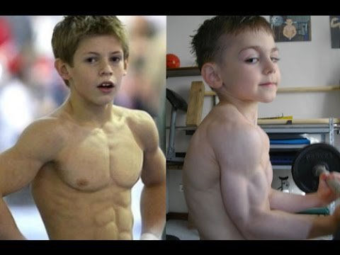 Two young boys showcase muscular physiques. One poses outdoors; the other lifts a dumbbell indoors. Background features fitness equipment.