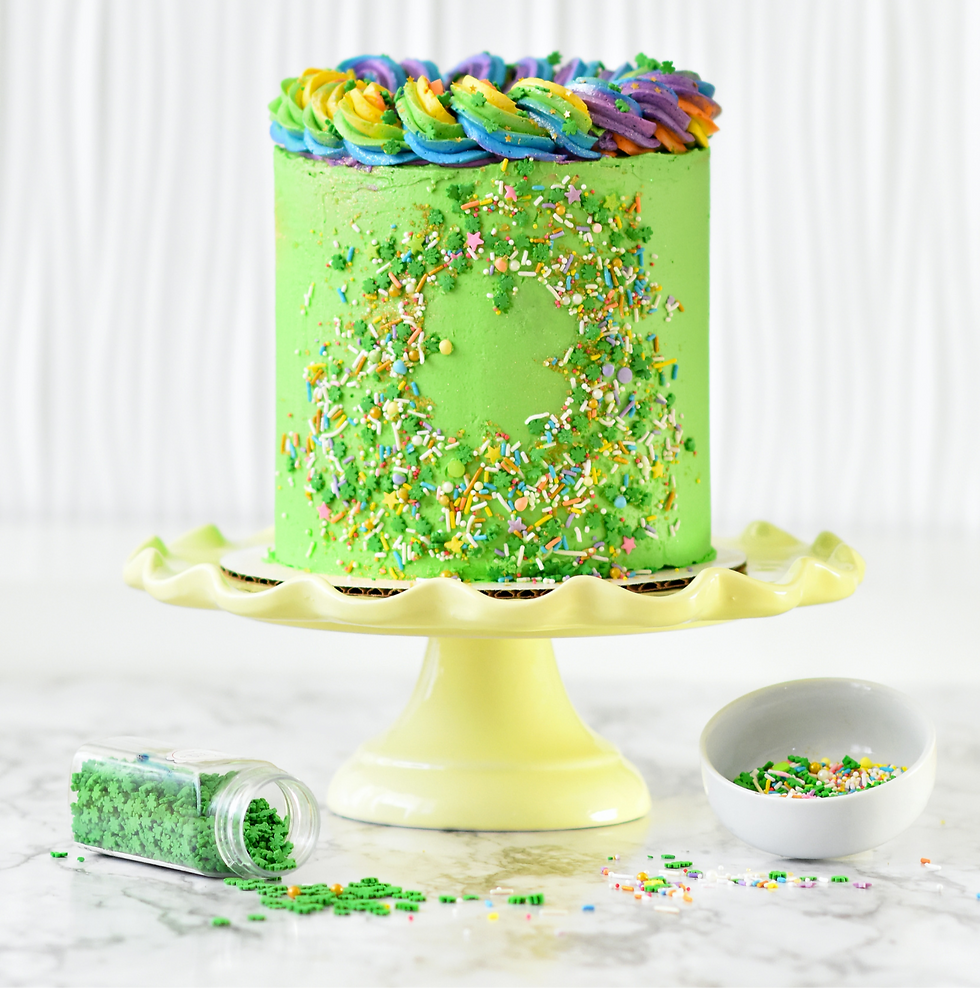 Green cake with rainbow frosting and sprinkles