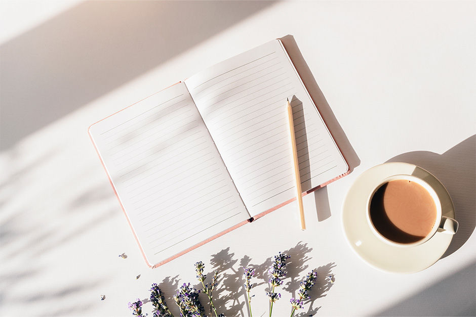 Open notebook and pen on a desk, representing reflection and lessons learned.