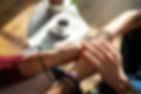 Hands reaching in connection, symbolizing compassion and support.