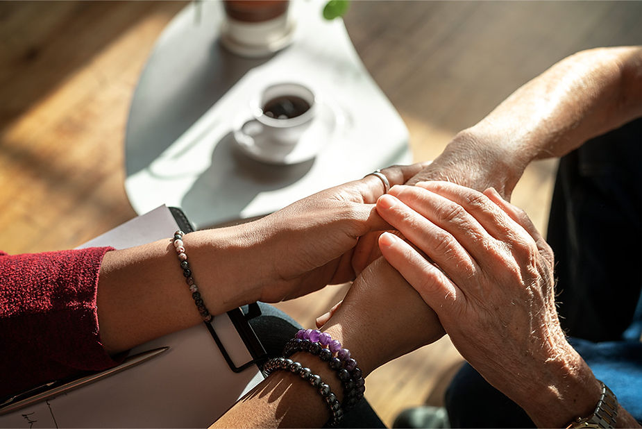 Hands reaching in connection, symbolizing compassion and support.