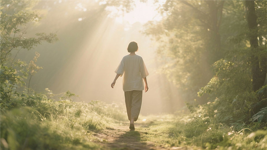 Person walking through sunlight in nature, symbolizing self-acceptance and healing