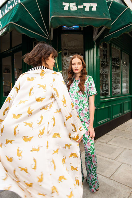 Models wearing printed pyjamas designed for Yolke in an urban setting.