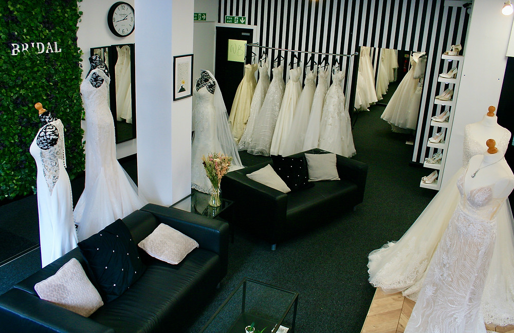 Willow Bridal's Boutique Interior with black leather sofas and striped wall.