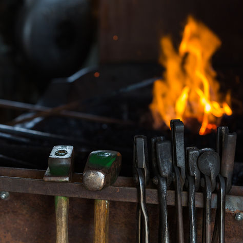 iron tools by a fire