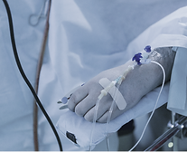 Person in hospital with needles and pipes in hand