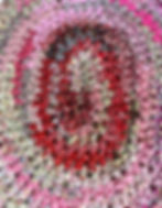 Thumbnail: Intricate pink and red crocheted rug