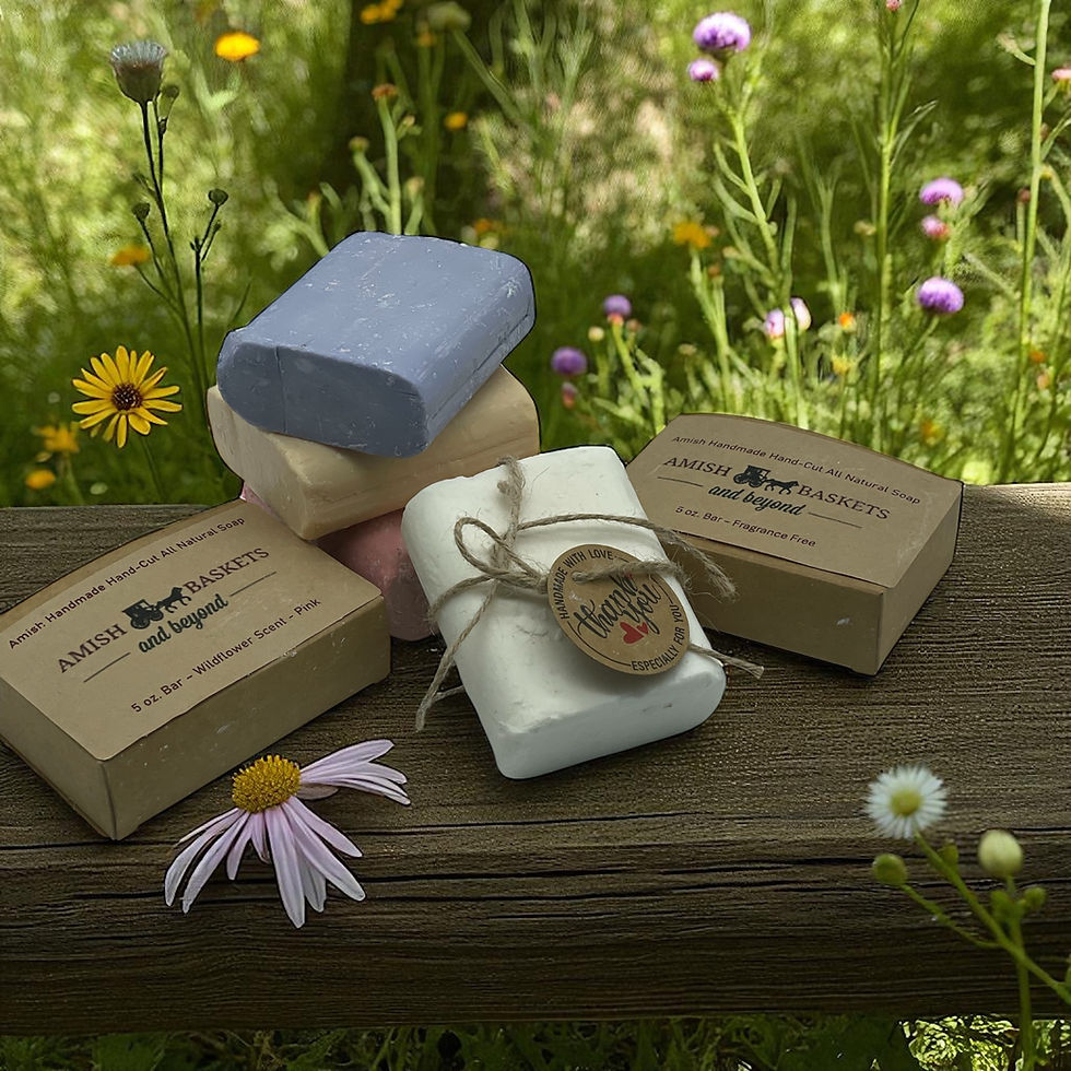 Stacked soaps with tags on a wooden table with wildflowers in background.