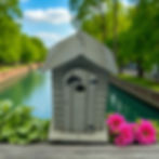 Charming outhouse birdhouse by canal