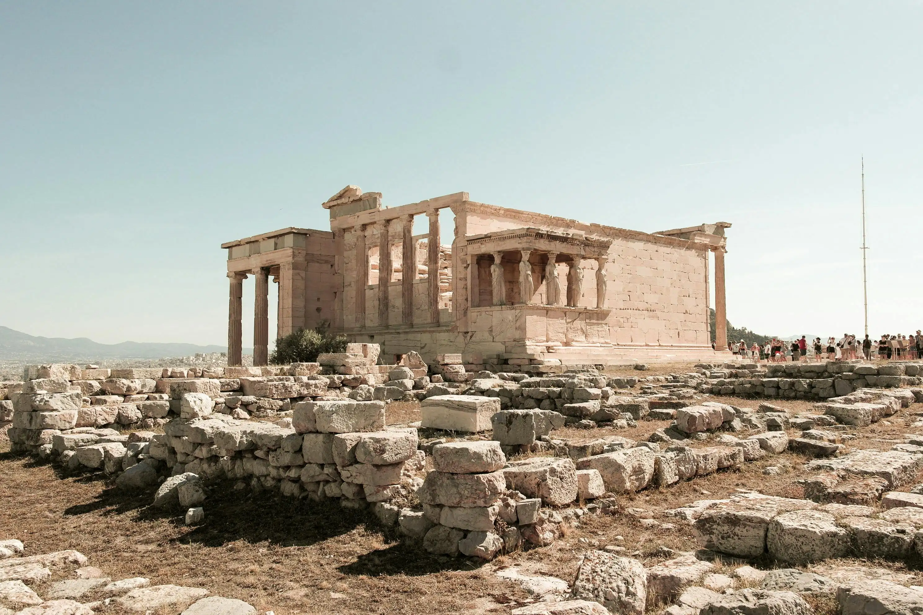Ruins of the Acropolis in Athens under a blue sky, a destination in Europe with living history to explore in 2025.
