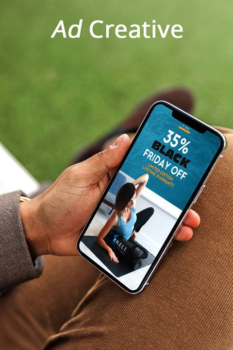 Person holding a phone displaying a digital ad, representing ad creative services for online marketing.