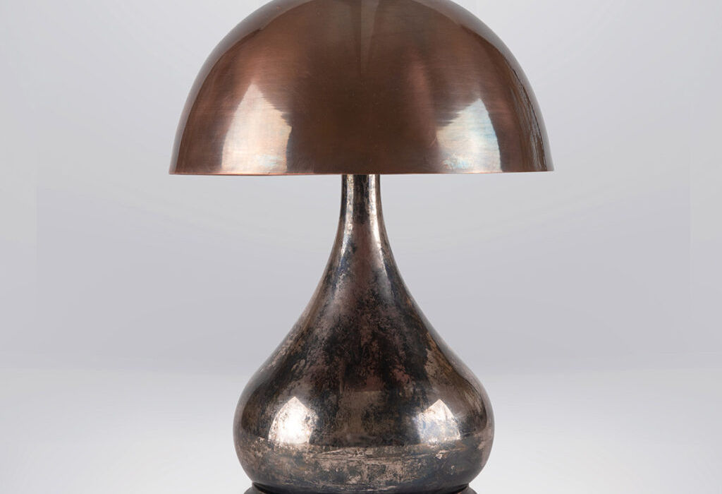 Potbelly table lamp in antique nickel with an aged ebony base and a hemispherical brass shade for diffused lighting.