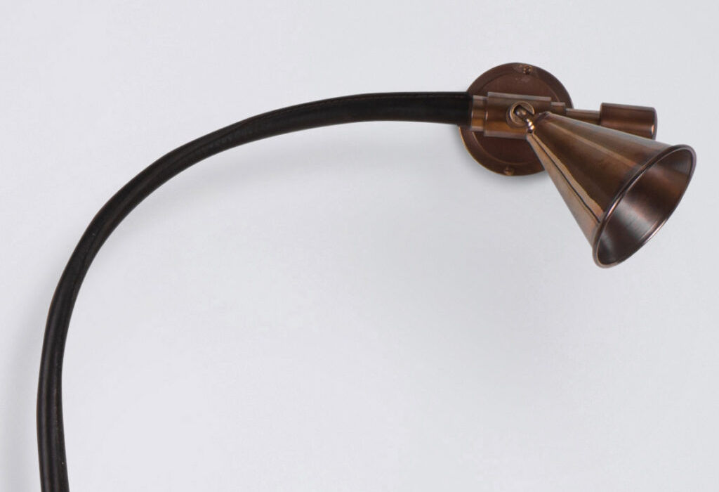 Adjustable spotlight bar with three brass conical shades and leather-wrapped bar, perfect for artwork lighting.