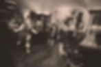 Live band performing in a bar, with swing dancers out in front.