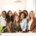 A soft, modern scene showing a diverse group of professionals (30s to 50s) smiling in a br