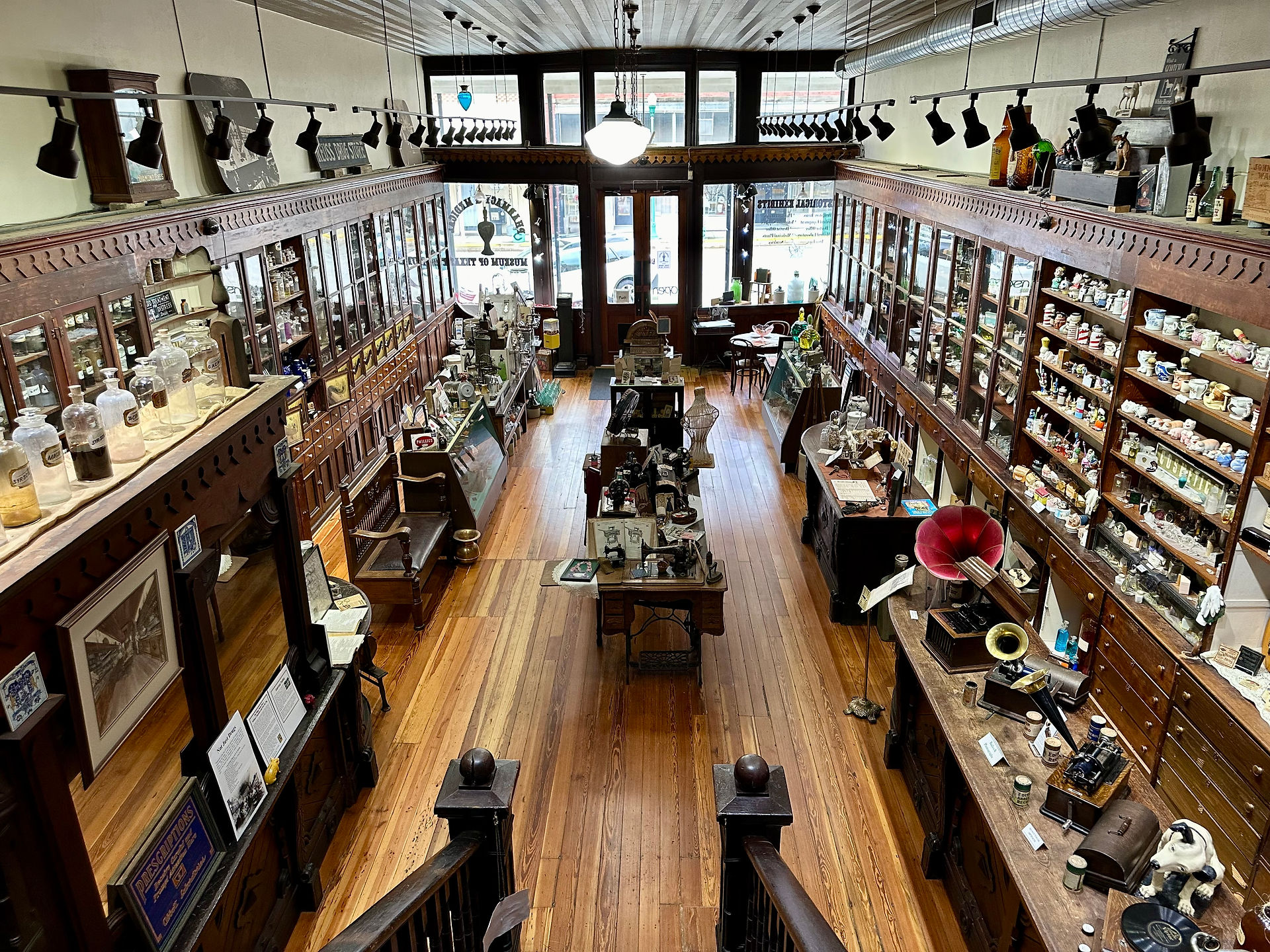 The view from the 2nd floor of the Pharmacy and Medical Museum. On both sides are vintage medicine bottles and other vintage medical items