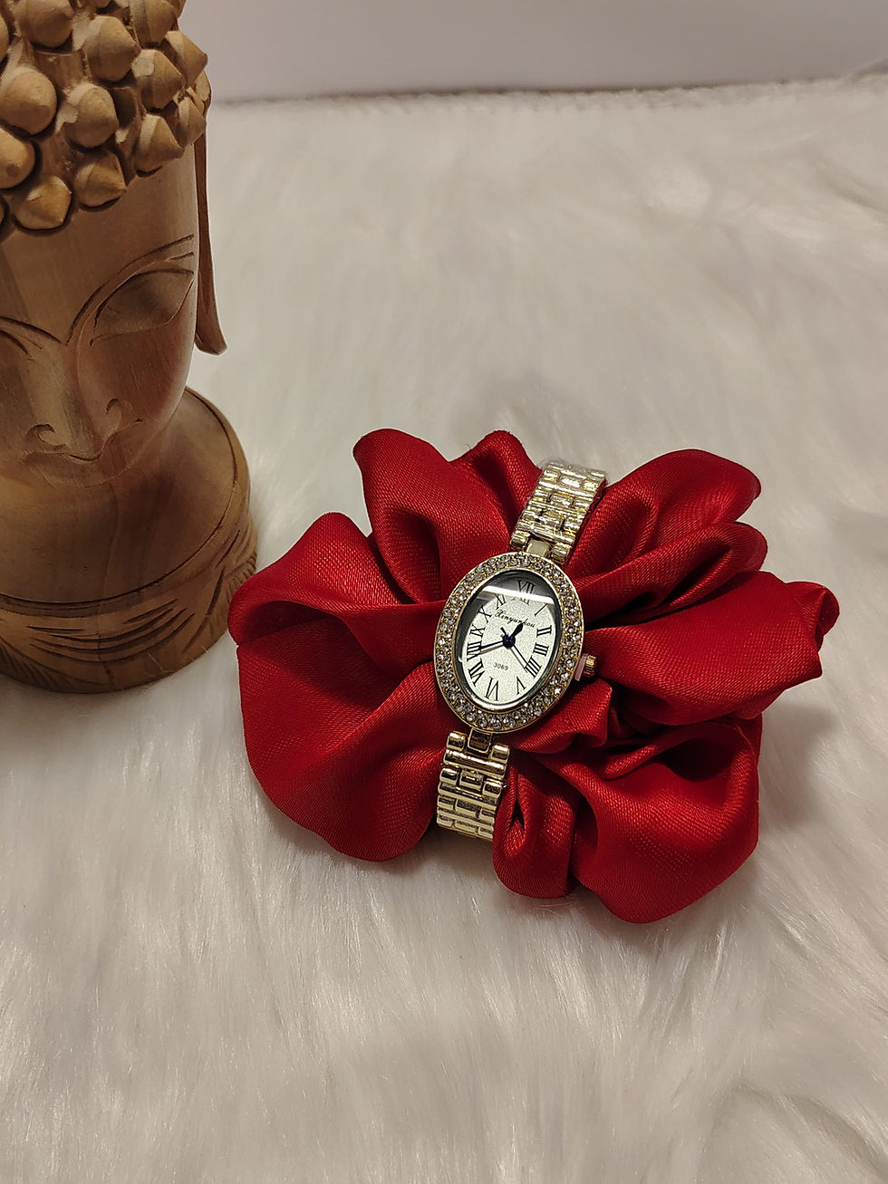 Oval diamond design watch on a red silk scrunchie