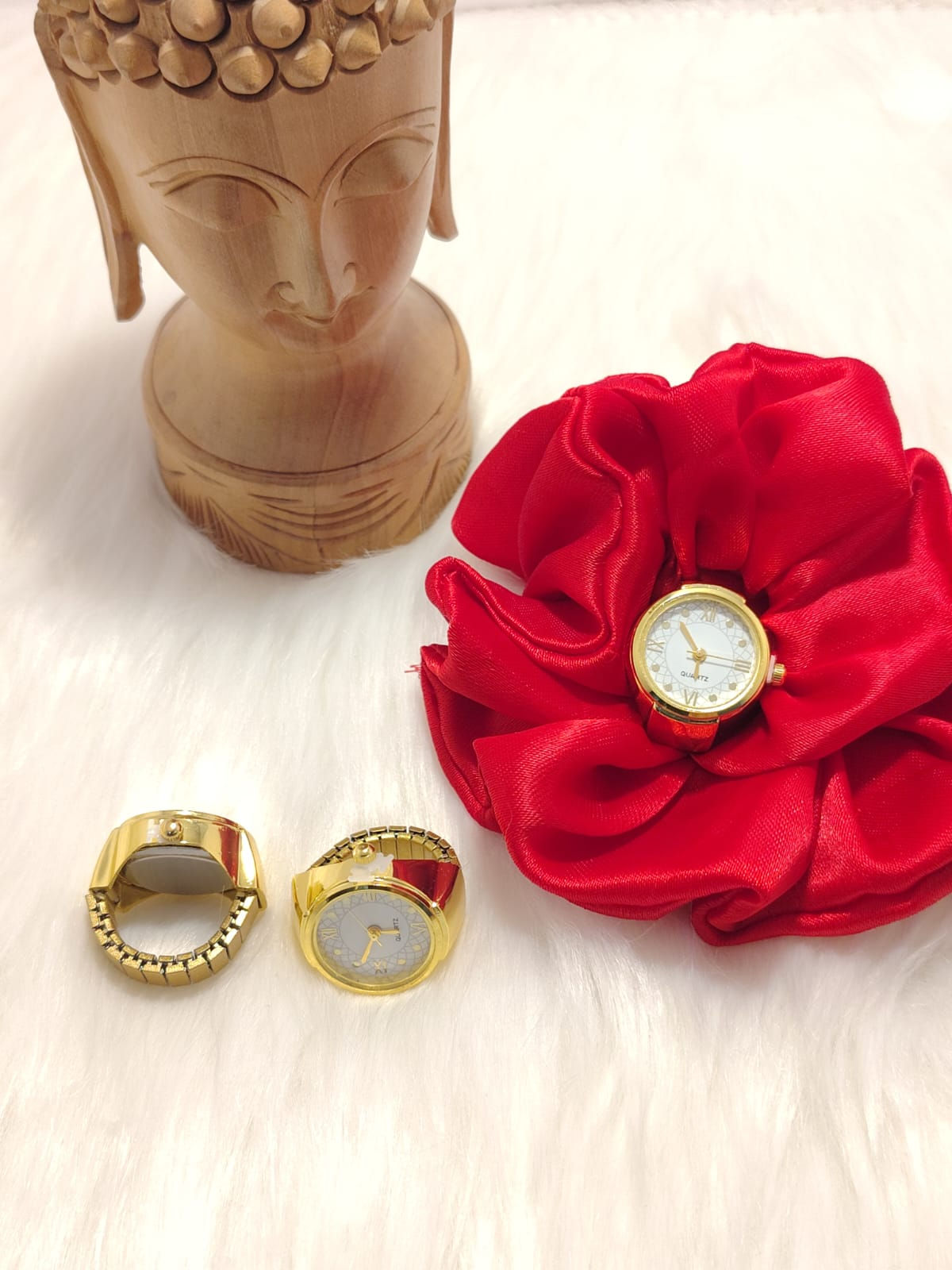 White ring watch on red silk scrunchie with gold rings