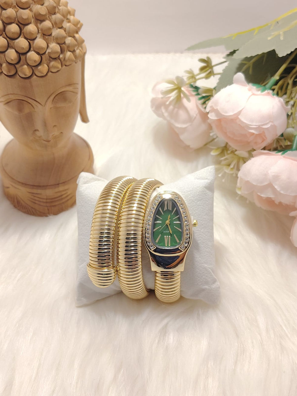 Triple Round Watch with green face on white pillow