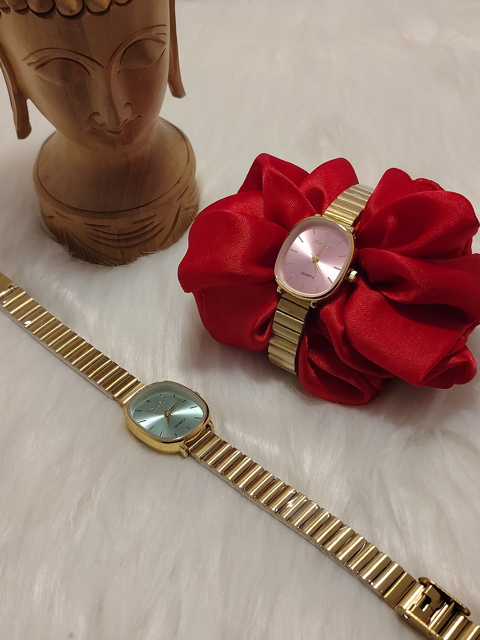 Gold oval dial watch with pink and blue faces