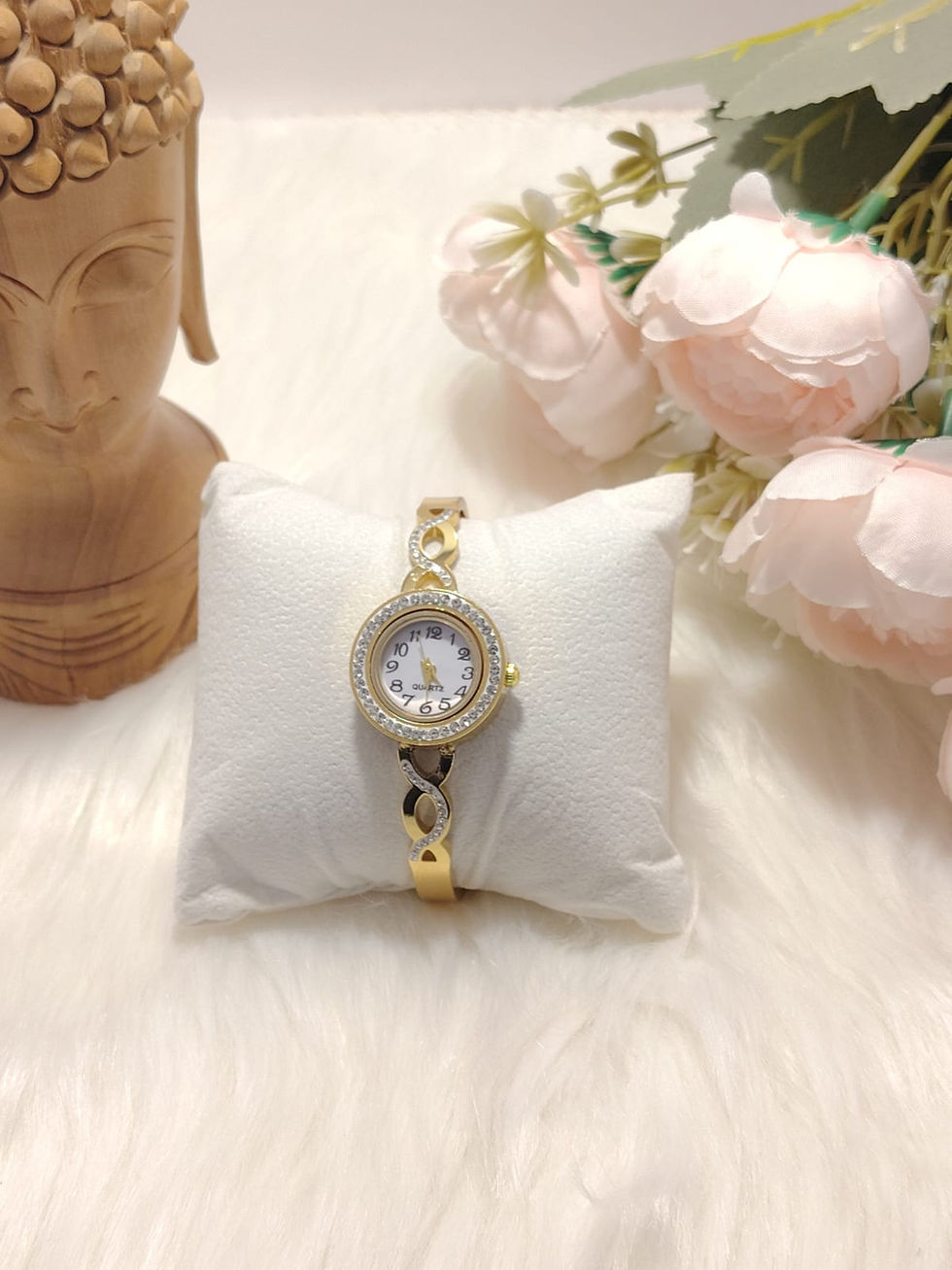 Gold Bracelet Watch 4 with crystal bezel on a white pillow