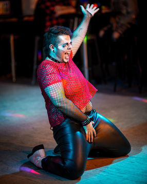 A man performing drag down on his knees