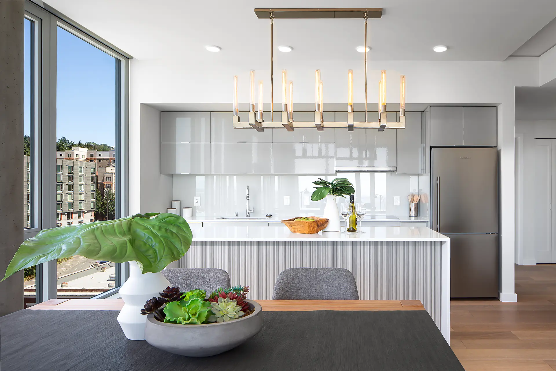 The Koda Condo interior kitchen features top-of-the-line appliances, a modern and functional layout, and plenty of storage space, making it the perfect space for preparing meals and hosting gatherings.