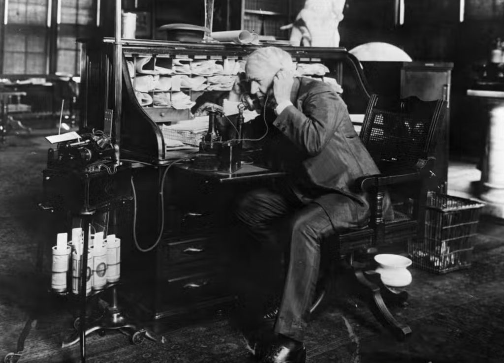 Thomas Edison speaking on the phone at this desk