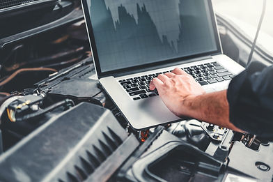 cropped-hand-mechanic-using-laptop-while-repairing-car-engine.jpg