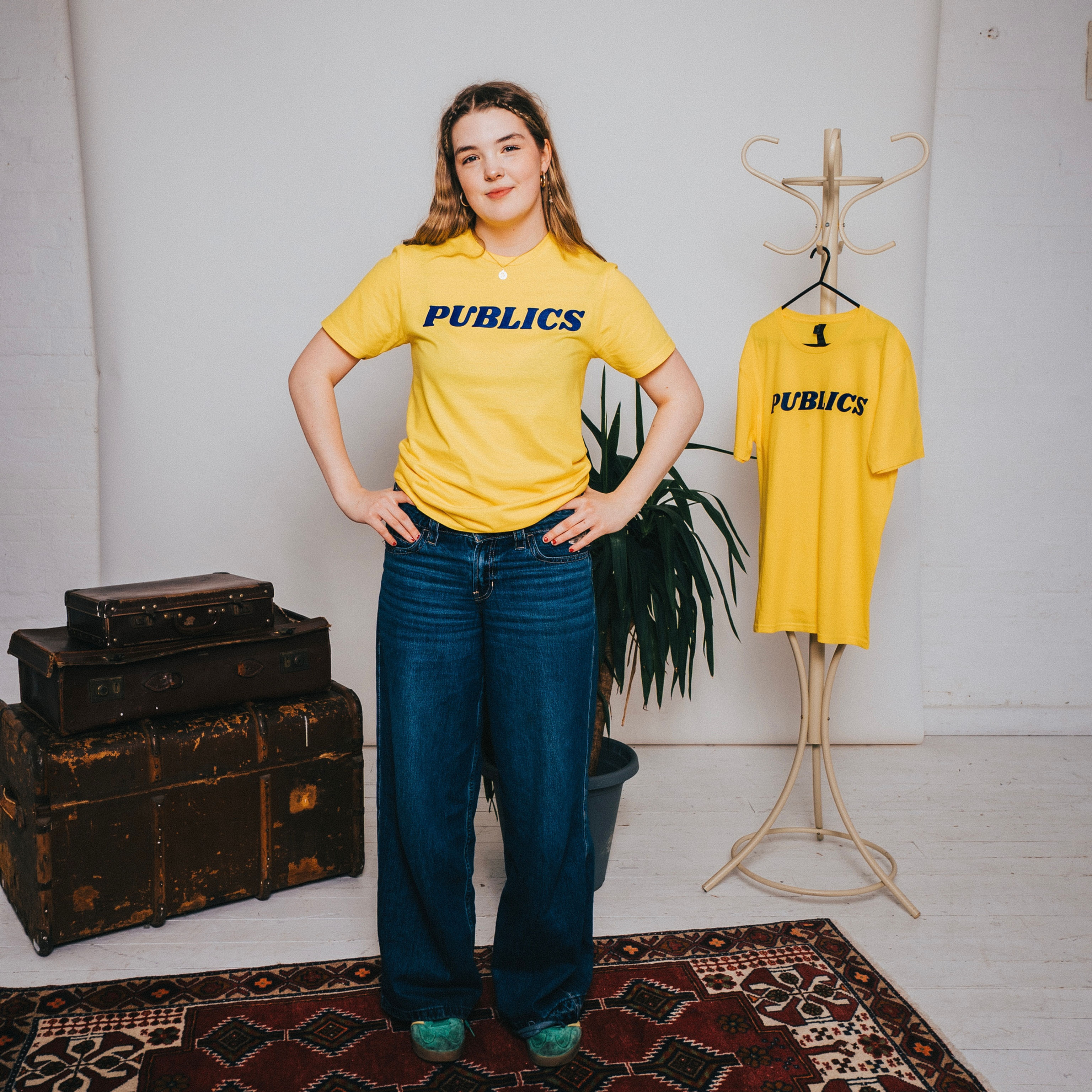 A Female model wearing The Publics Classic T-Shirt in Yellow/Blue