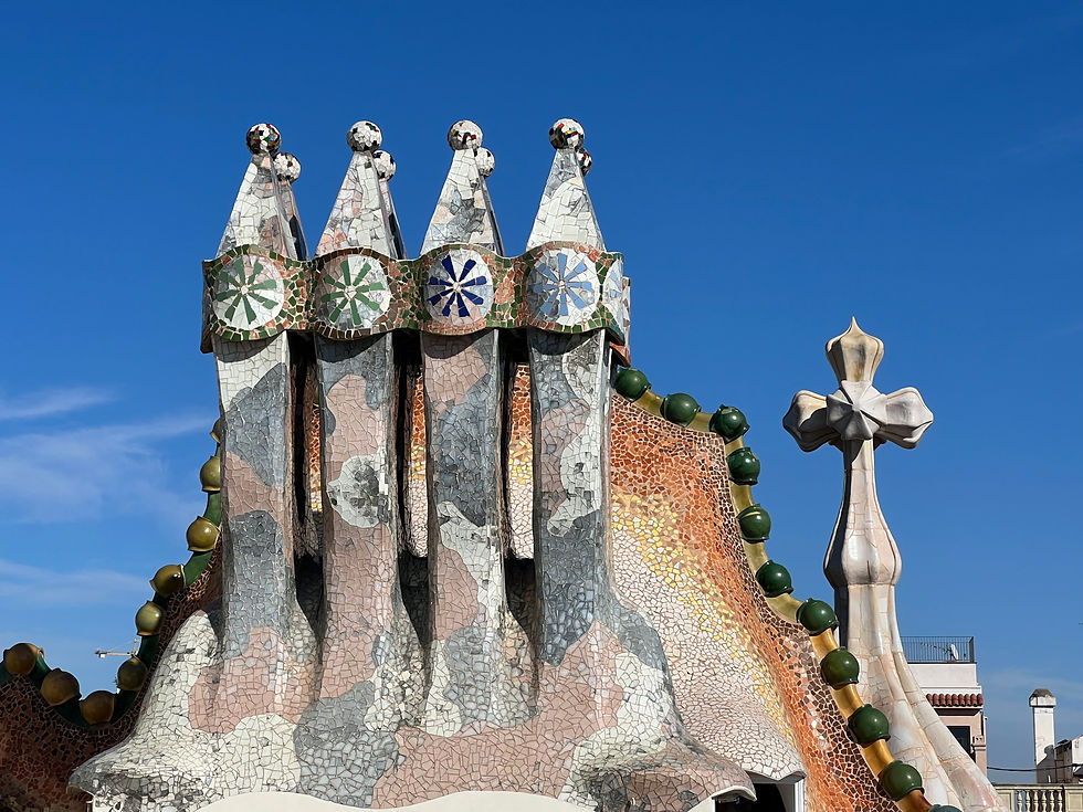 Stone pointed statues with a green ridge of stone behind them