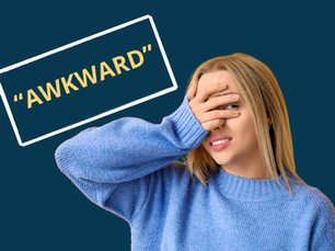 An awkward-looking blonde teen girl holds one hand over her eyes, peeking through the gap in her fingers. She is wearing a light blue jumper. The background is dark blue and there is a text book next to her with the words "awkward" in it