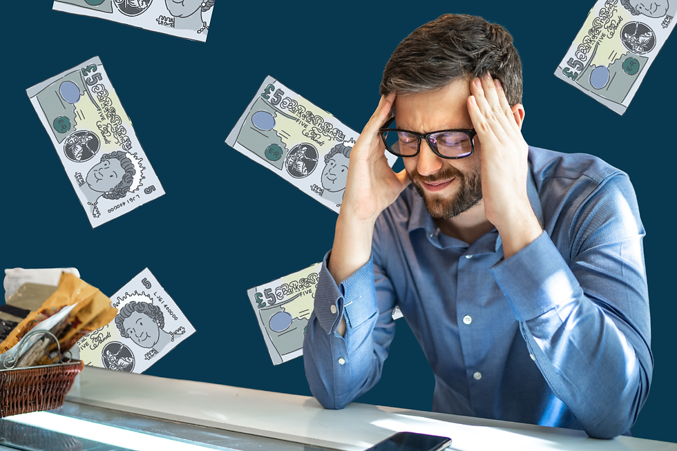 A stress man with glasses, facial hair, and a blue dress shirt, sits at a desk. There are cartoon £5 notes floating behind him. The background is dark blue.