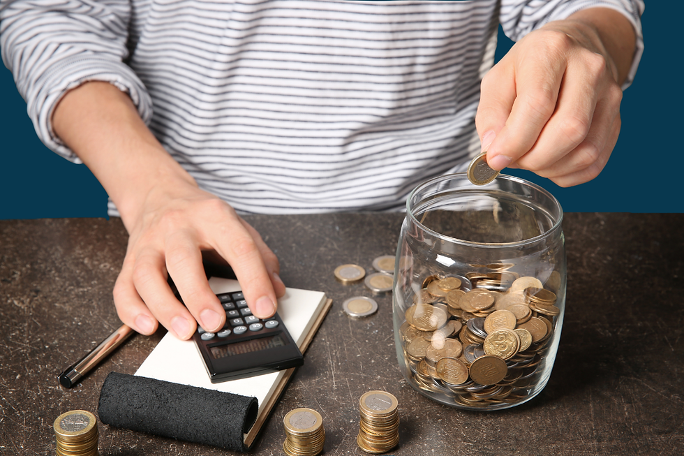 Person in a striped shirt counts coins into a glass jar with a calculator on a notebook, with more coins scattered on a dark table.