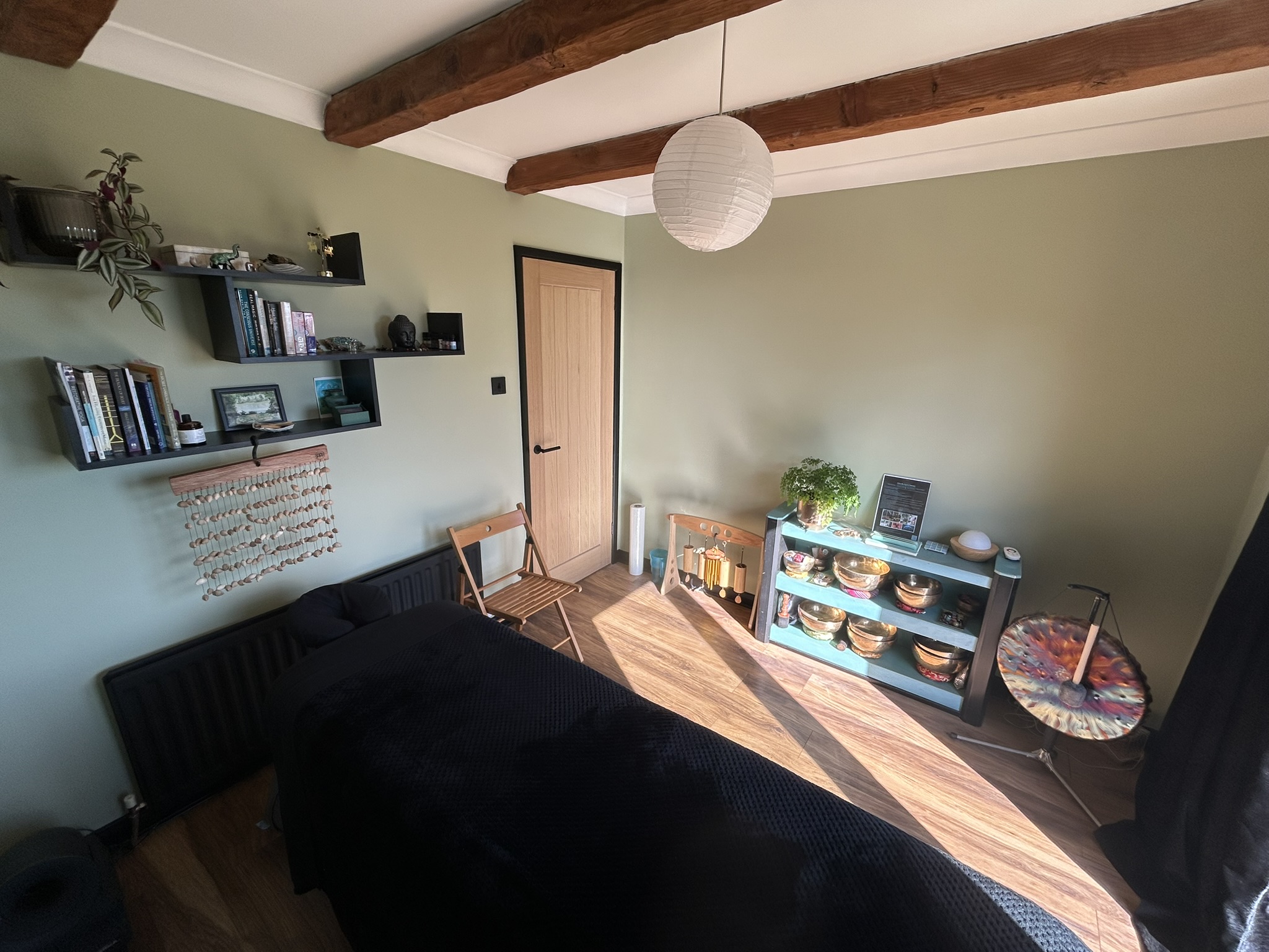 A tranquil and healing sound therapy treatment room highlighting soft lighting and cozy mats