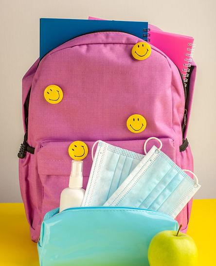 front-view-child-school-bag-with-copybooks-spray-masks-yellow-desk.jpg
