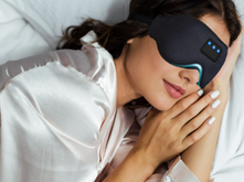 woman sleeping with a laser sleep mask