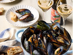 Table of food with a bottle of wine