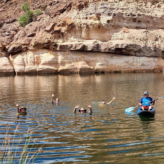 People swimming and kayaking in Ellendale Pool