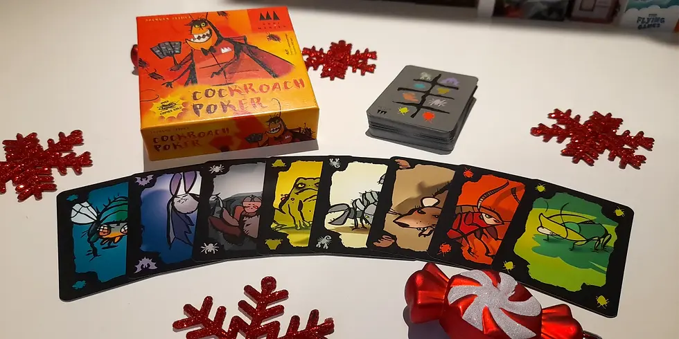 Cockroach Poker card game on a table, featuring colorful insect cards and festive red snowflake decorations around the game box.