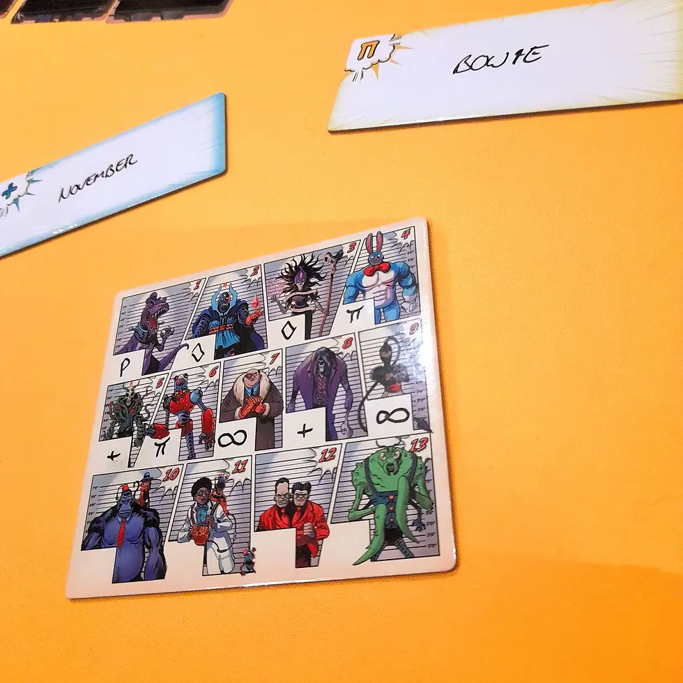 Comic-style character cards on an orange surface, with handwritten labels "November" and "Bowie." Various symbols and colorful designs.