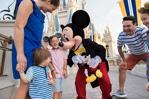 Mickey Mouse at Magic Kingdom making kids laugh