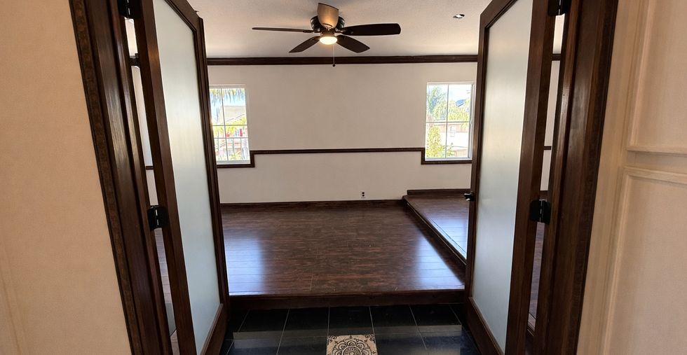 Upstairs loft with dark wood flooring and open layout