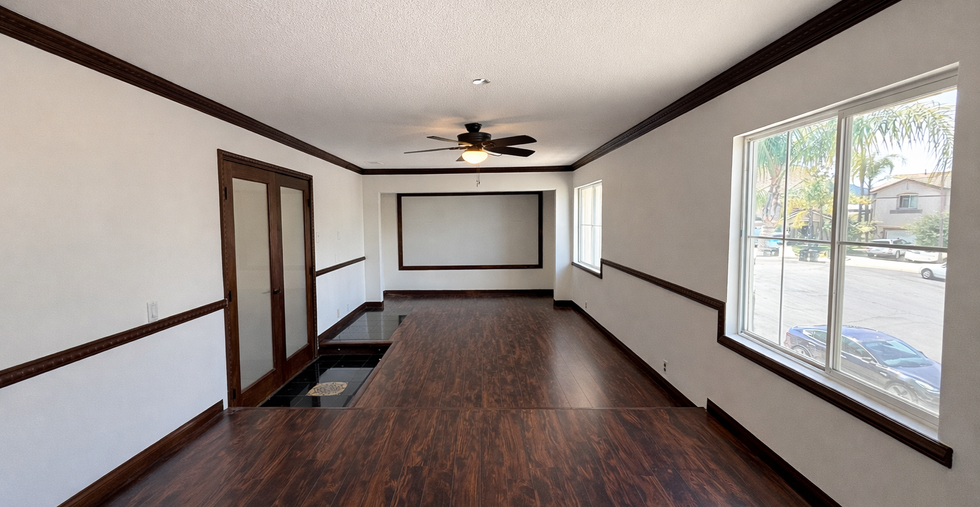 Upstairs loft with dark wood flooring and open layout